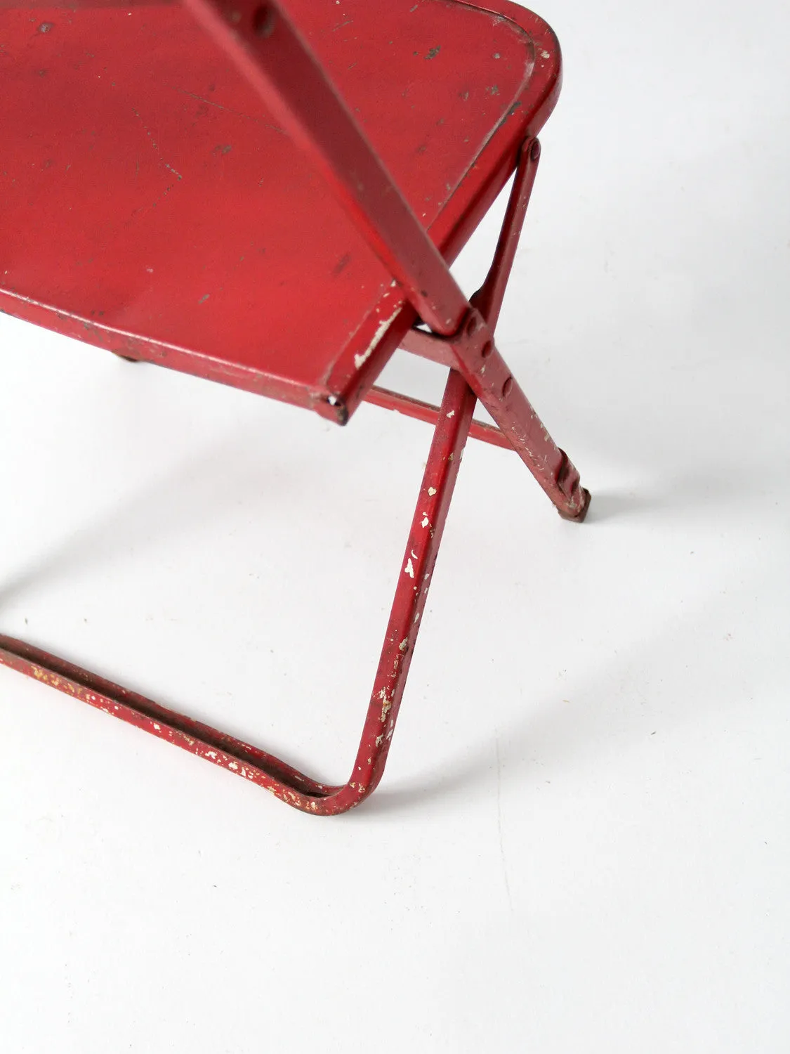 red children's folding chair circa 1950